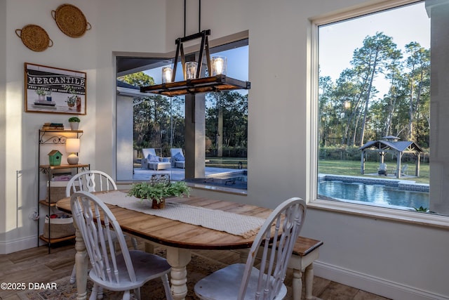 dining area with wood-type flooring and a chandelier