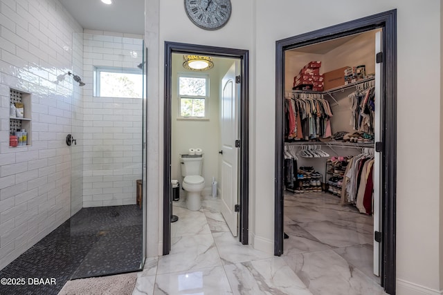 bathroom with walk in shower and toilet