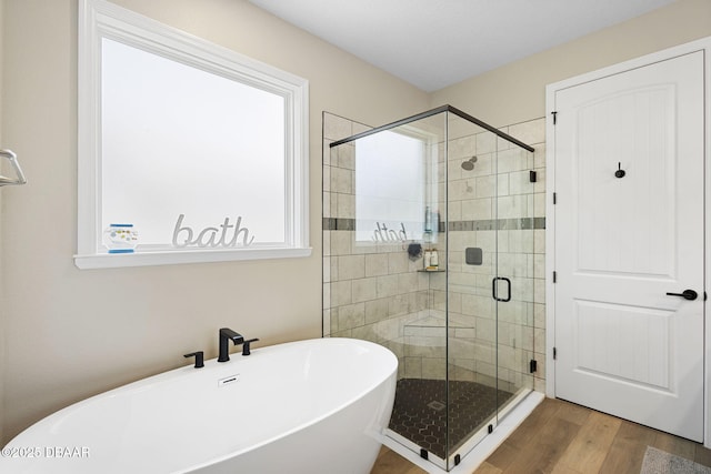 1602 Killian Drive Ne, Palm Bay, FL 32905 - bathroom with a freestanding tub, a stall shower, and wood finished floors