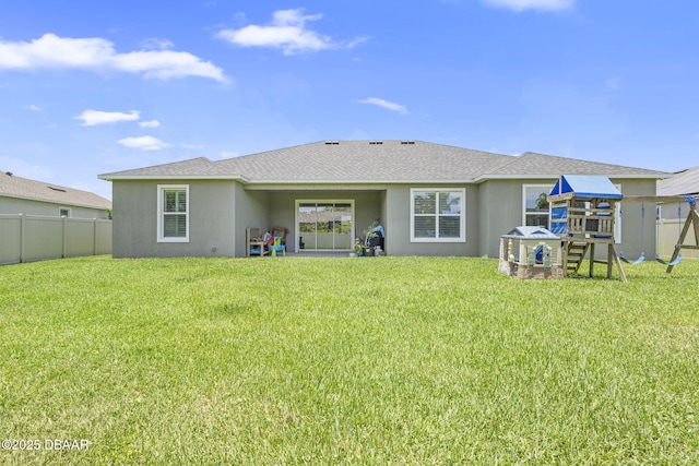 1602 Killian Drive Ne, Palm Bay, FL 32905 - back of property featuring a playground, stucco siding, and a shingled roof