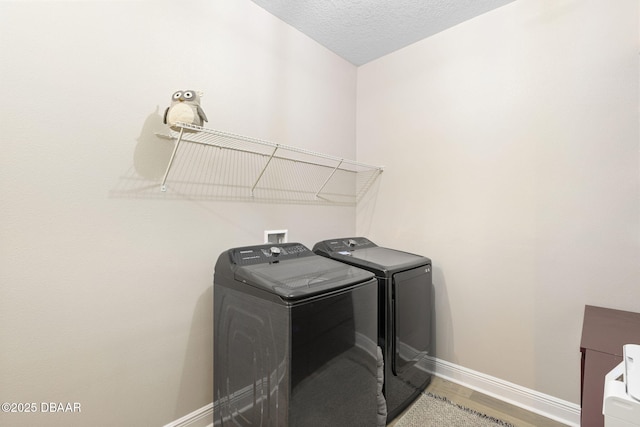 1602 Killian Drive Ne, Palm Bay, FL 32905 - washroom featuring washing machine and clothes dryer, wood finished floors, and a textured ceiling