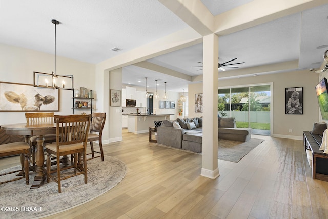 1602 Killian Drive Ne, Palm Bay, FL 32905 - dining space with a chandelier, light wood finished floors, and ceiling fan