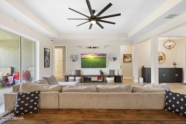 1602 Killian Drive Ne, Palm Bay, FL 32905 - living area featuring a ceiling fan, wood finished floors, a raised ceiling, and a chandelier