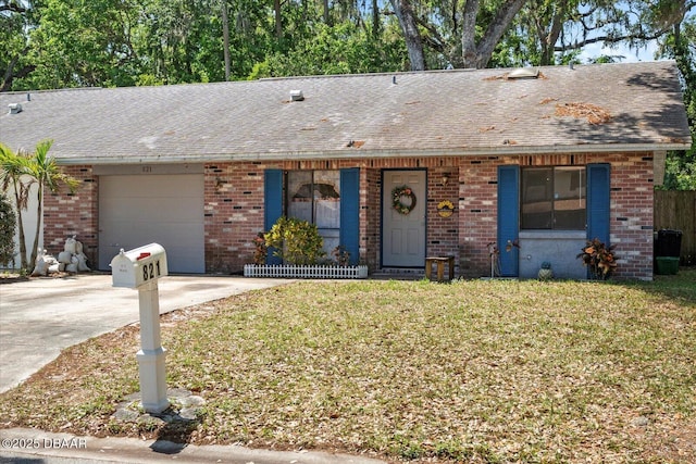 ranch-style home with a garage, brick siding, a front lawn, driveway, and roof with shingles