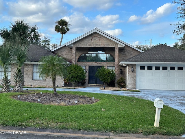 view of front of property with a garage and a front yard