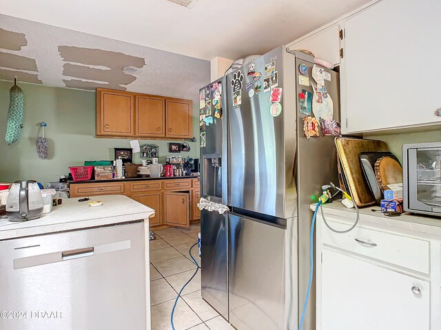 kitchen featuring white cabinetry, light tile patterned floors, and appliances with stainless steel finishes