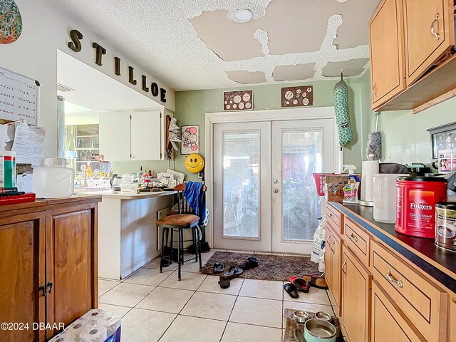 kitchen featuring a textured ceiling, plenty of natural light, and french doors