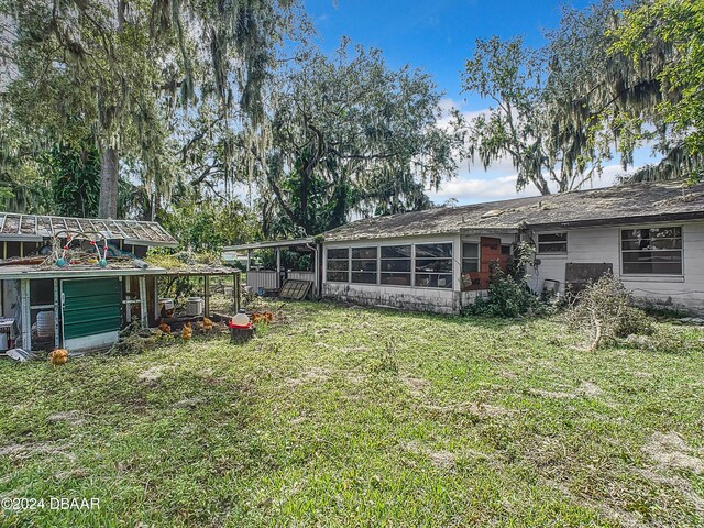 view of yard featuring a sunroom