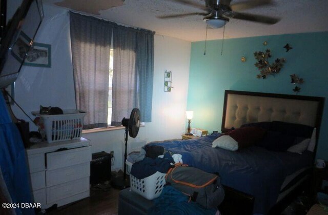 bedroom with wood-type flooring and ceiling fan