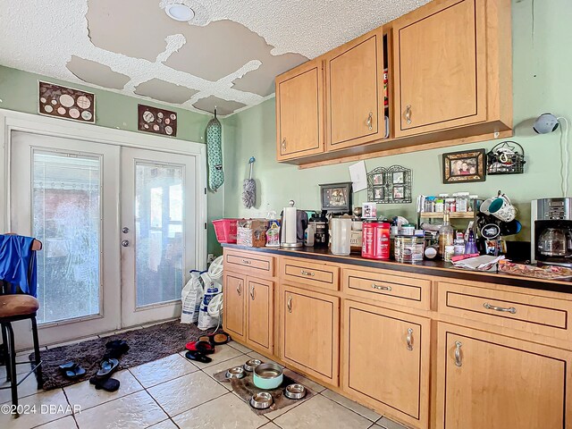 kitchen featuring a wealth of natural light, french doors, and a textured ceiling