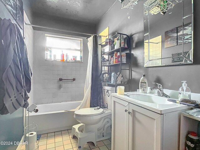 full bathroom featuring toilet, vanity, shower / bath combination with curtain, and tile patterned flooring