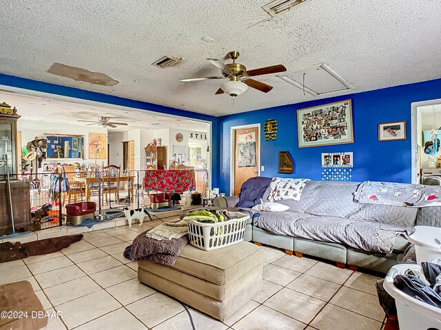 tiled living room featuring a textured ceiling and ceiling fan