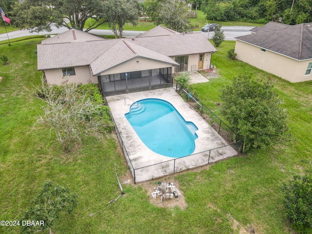 view of swimming pool with a patio, a sunroom, and a yard