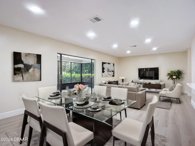 dining space with light hardwood / wood-style flooring