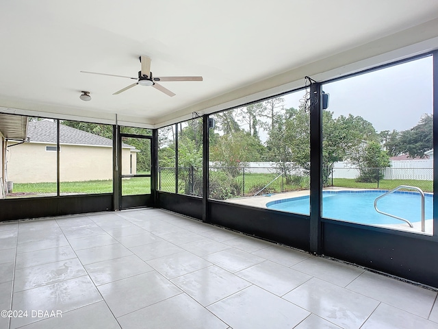 unfurnished sunroom featuring ceiling fan