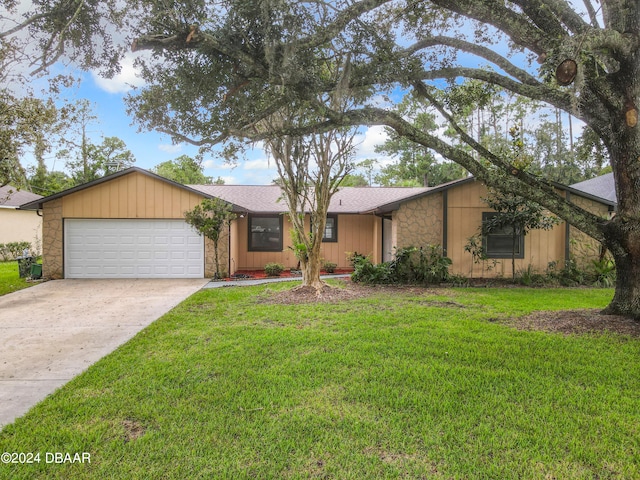 single story home featuring a garage and a front lawn