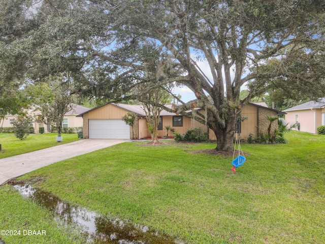 single story home featuring a garage and a front yard