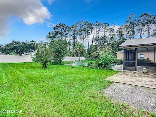 view of yard featuring a sunroom and a patio area