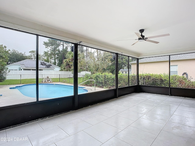 unfurnished sunroom featuring ceiling fan