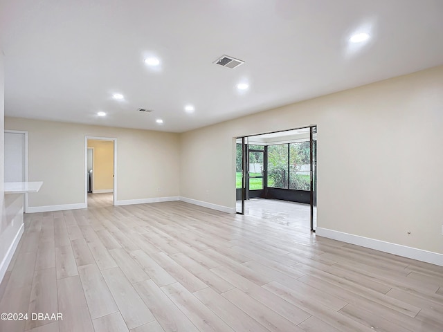 empty room with light hardwood / wood-style floors