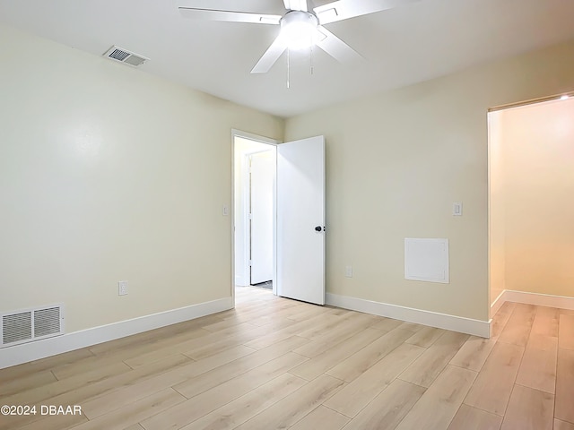 unfurnished room featuring ceiling fan and light wood-type flooring