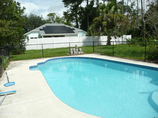 view of pool featuring a patio area and a lawn