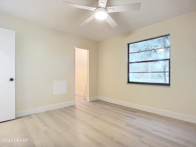 empty room featuring ceiling fan and light hardwood / wood-style floors