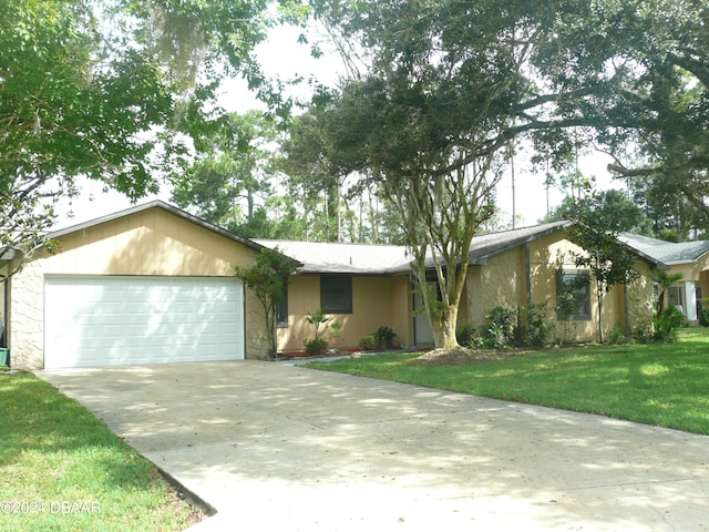 ranch-style house featuring a front lawn and a garage