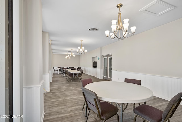 dining area featuring a chandelier and wood-type flooring