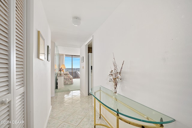 hall featuring light tile patterned flooring