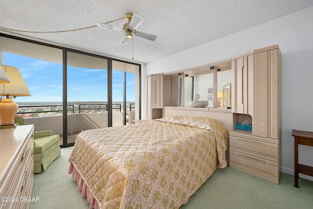 carpeted bedroom with a textured ceiling and ceiling fan