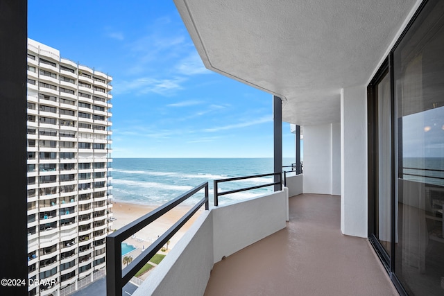 balcony with a view of the beach and a water view