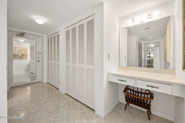 hall with light tile patterned flooring