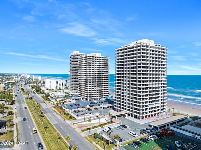 birds eye view of property featuring a beach view and a water view