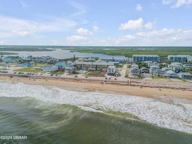 drone / aerial view with a water view and a beach view