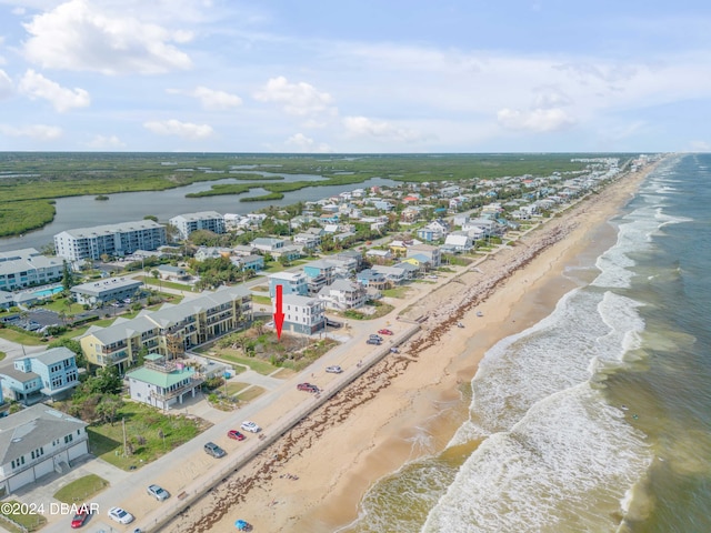 birds eye view of property featuring a view of the beach and a water view