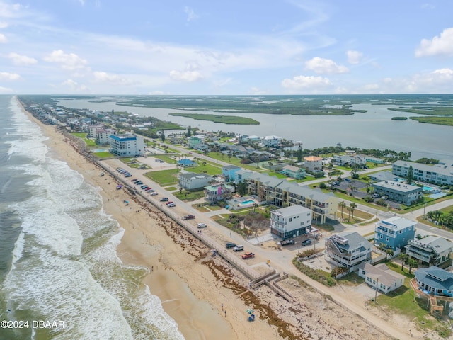 birds eye view of property with a beach view and a water view