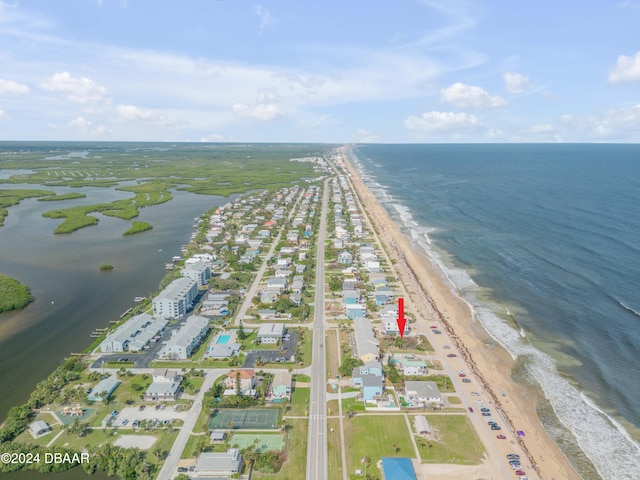 drone / aerial view with a beach view and a water view