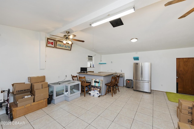 4245 Cardinal Blvd, Port Orange, FL 32127 - kitchen with visible vents, freestanding refrigerator, a ceiling fan, lofted ceiling with beams, and light tile patterned floors