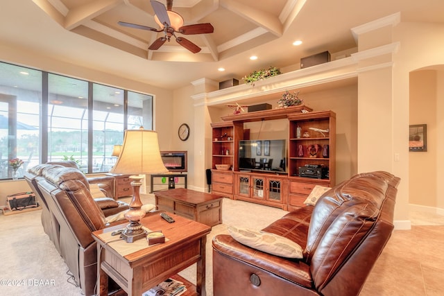 living room with ceiling fan, crown molding, a high ceiling, and coffered ceiling