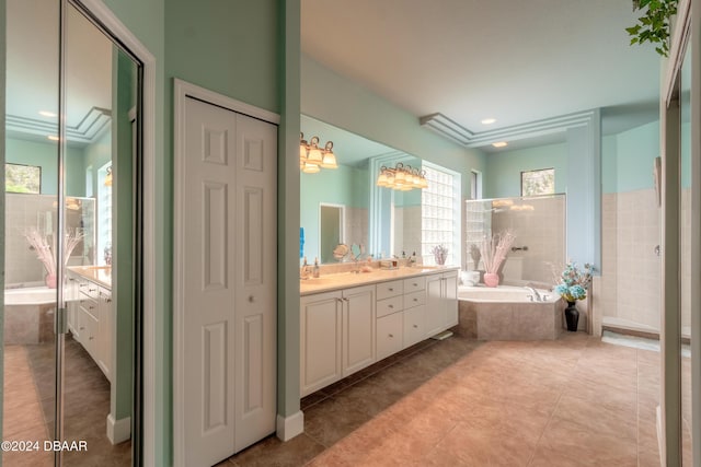 bathroom featuring tile patterned flooring, vanity, and shower with separate bathtub