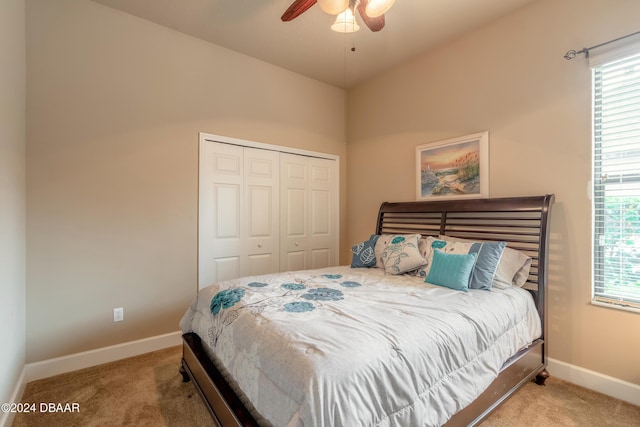 carpeted bedroom with a closet and ceiling fan