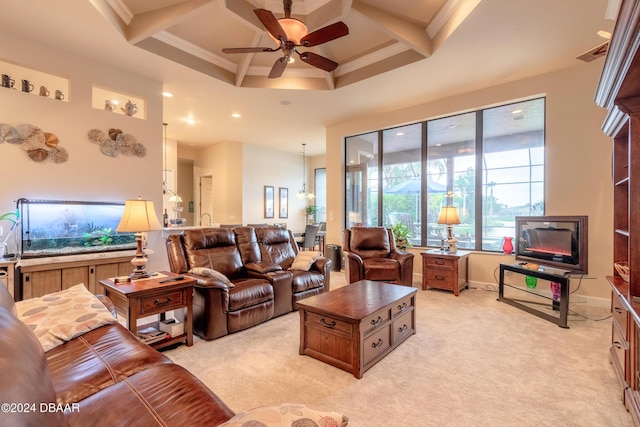 carpeted living room featuring beam ceiling, ceiling fan, coffered ceiling, and ornamental molding