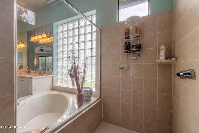 bathroom with vanity, separate shower and tub, and a wealth of natural light