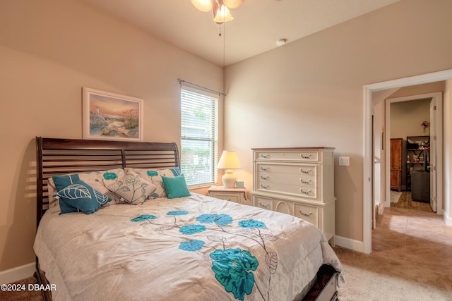 bedroom featuring ceiling fan and light carpet