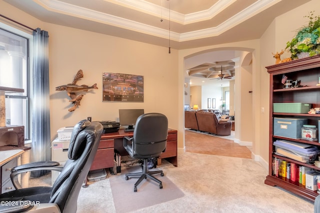 office area featuring ceiling fan, a raised ceiling, light carpet, and crown molding