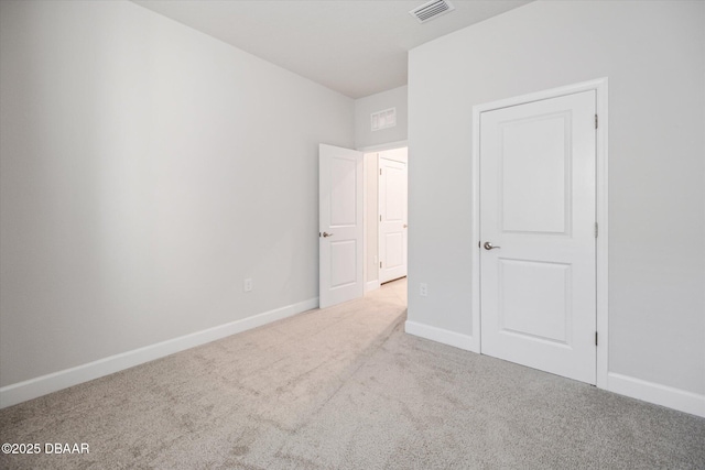 unfurnished bedroom with visible vents, baseboards, and carpet flooring