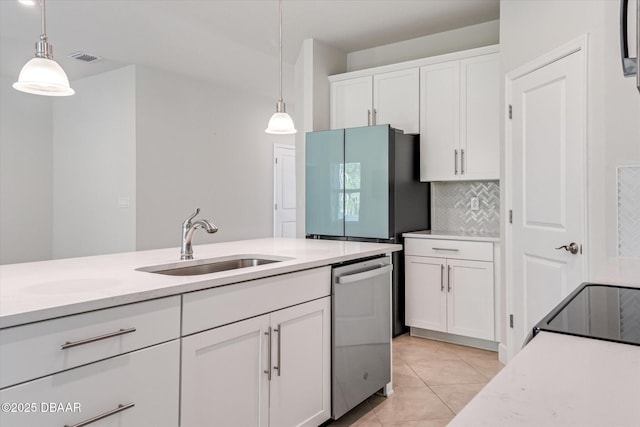 kitchen featuring dishwasher, light countertops, freestanding refrigerator, white cabinets, and a sink