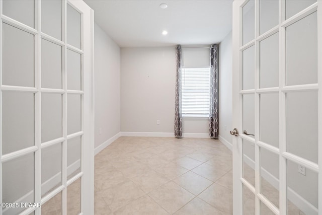 empty room with light tile patterned floors, recessed lighting, and baseboards