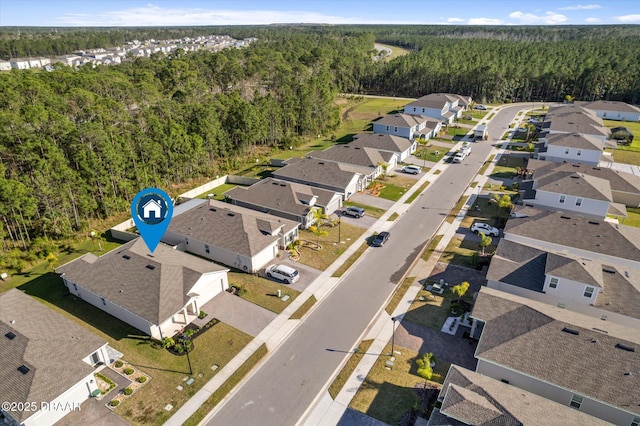 bird's eye view with a forest view and a residential view